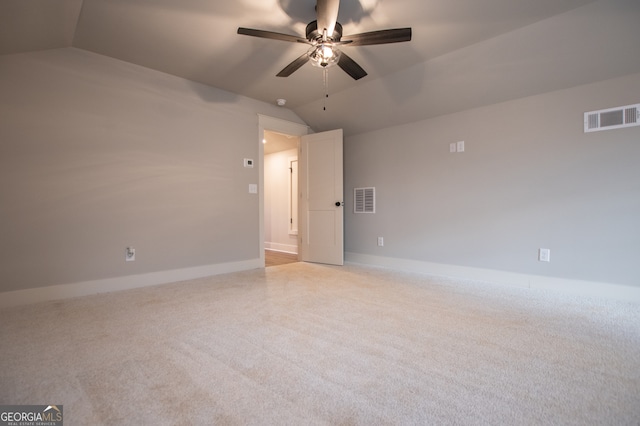 spare room featuring vaulted ceiling and ceiling fan