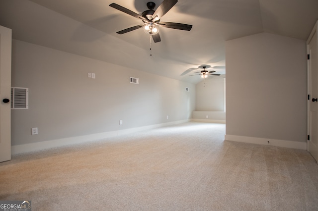 carpeted empty room with vaulted ceiling and ceiling fan