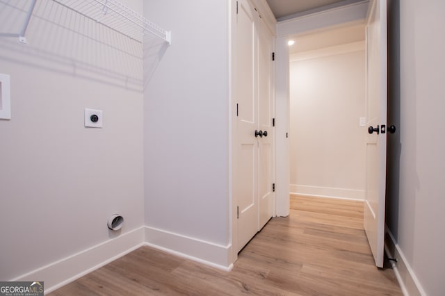 washroom with electric dryer hookup and light wood-type flooring