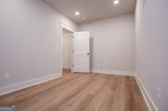 spare room with light hardwood / wood-style flooring