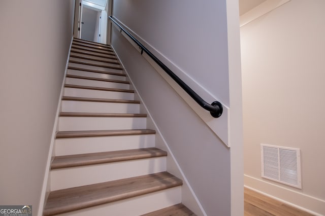 staircase featuring hardwood / wood-style floors