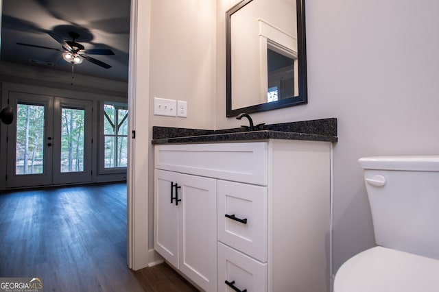 bathroom featuring vanity, toilet, ceiling fan, and wood-type flooring