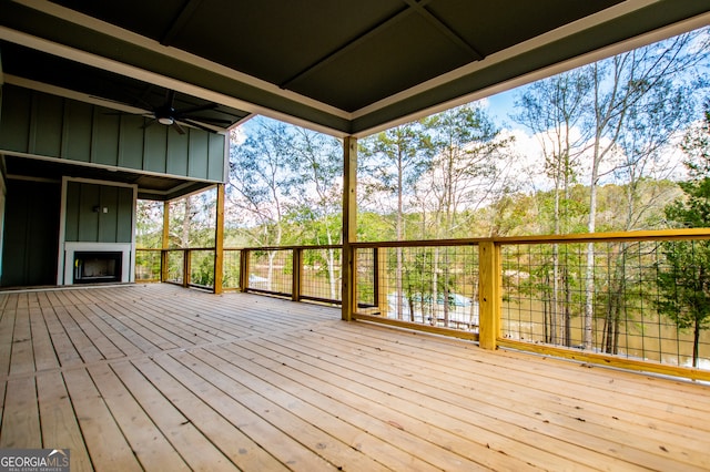 wooden deck featuring ceiling fan