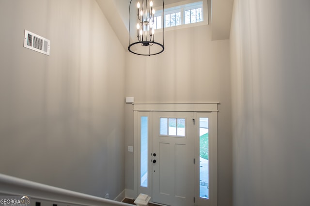 foyer entrance with plenty of natural light and an inviting chandelier