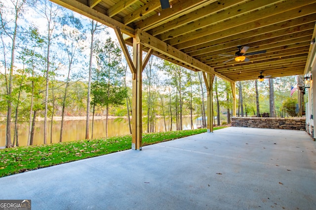 view of patio with a water view and ceiling fan