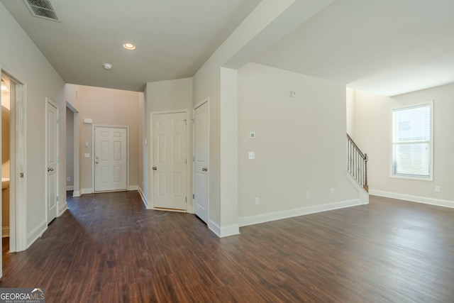 empty room with dark wood-type flooring