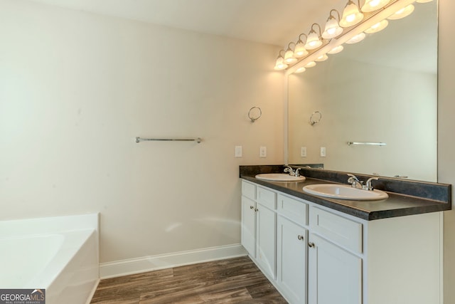 bathroom featuring a tub, wood-type flooring, and vanity