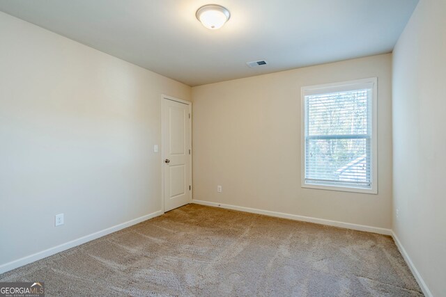 spare room with light colored carpet