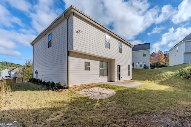 back of property featuring a patio and a lawn