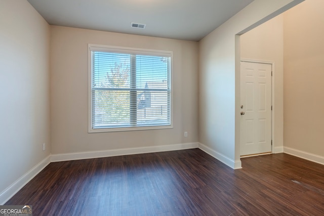 unfurnished room featuring dark hardwood / wood-style flooring