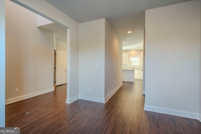 empty room with dark wood-type flooring