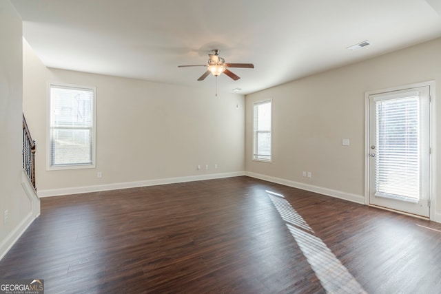 unfurnished room featuring ceiling fan, dark hardwood / wood-style flooring, and plenty of natural light