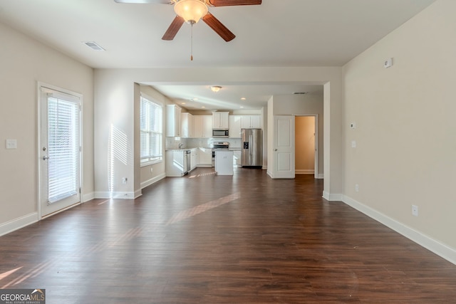 unfurnished living room featuring ceiling fan and dark hardwood / wood-style floors