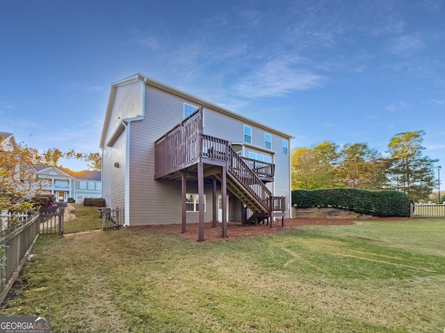 rear view of property with a yard and a deck