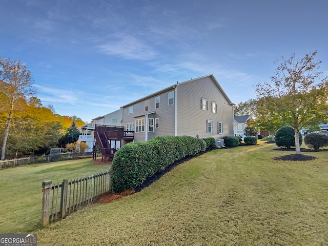 view of home's exterior featuring a yard and a wooden deck