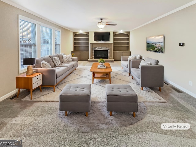 living room with carpet, built in features, ceiling fan, and ornamental molding