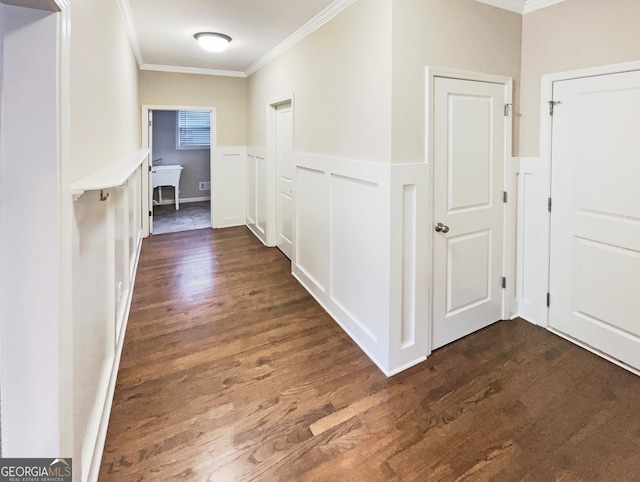 hall featuring ornamental molding and dark hardwood / wood-style flooring