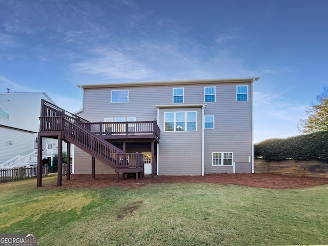 back of house with a yard and a wooden deck