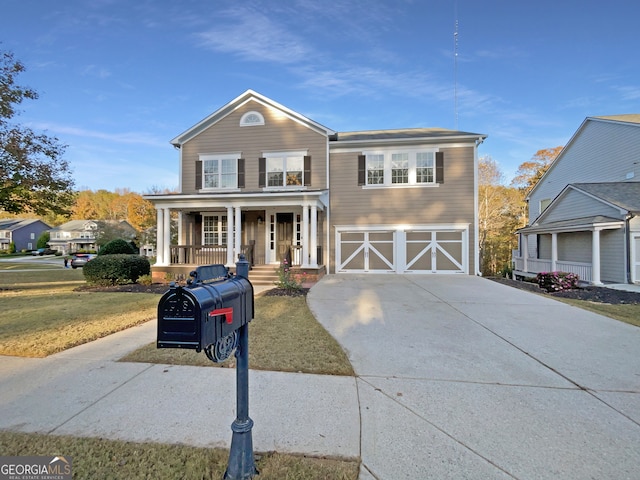 view of front of home featuring covered porch, a front yard, and a garage