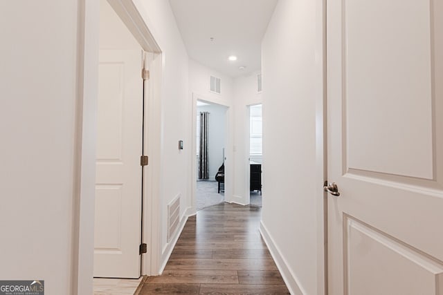 corridor with hardwood / wood-style floors