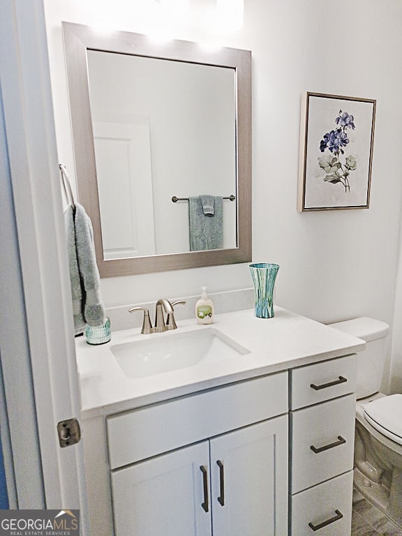 bathroom featuring vanity and toilet