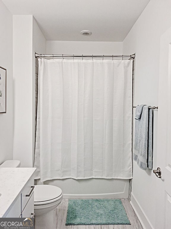 bathroom with vanity, hardwood / wood-style flooring, and toilet