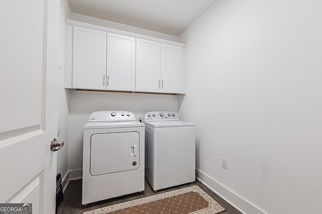 clothes washing area featuring cabinets and washing machine and dryer