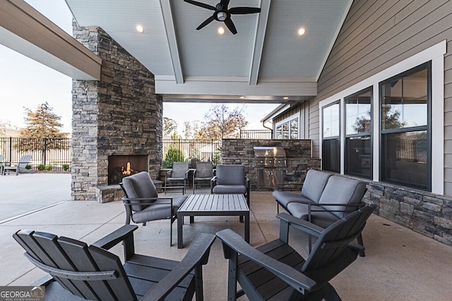 patio terrace at dusk featuring an outdoor living space with a fireplace, ceiling fan, and area for grilling