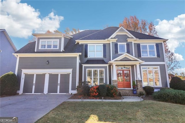 view of front of home featuring a front yard, french doors, and a garage