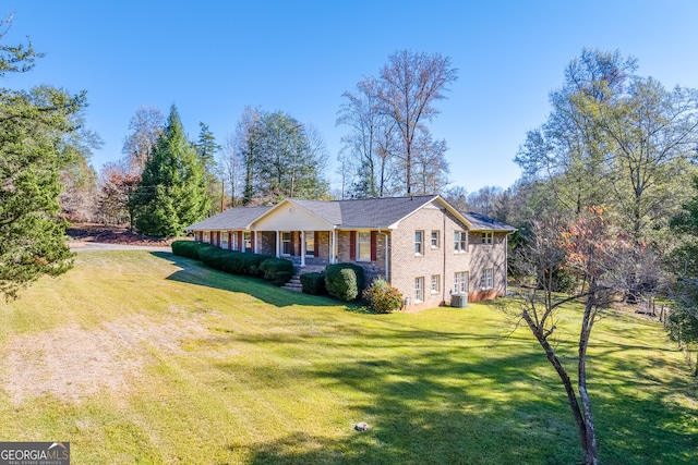 view of side of property featuring covered porch and a lawn