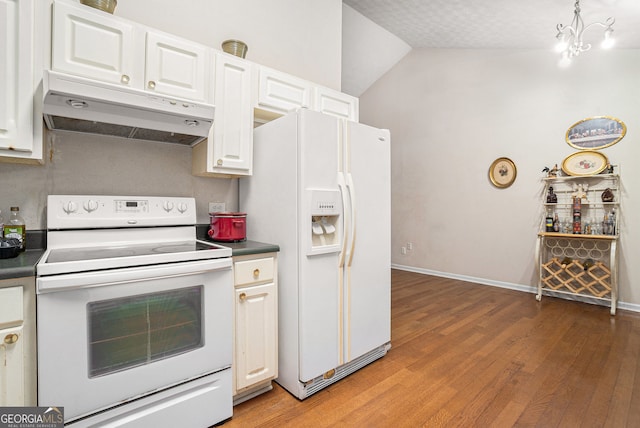 kitchen featuring white appliances, light wood finished floors, dark countertops, under cabinet range hood, and white cabinetry