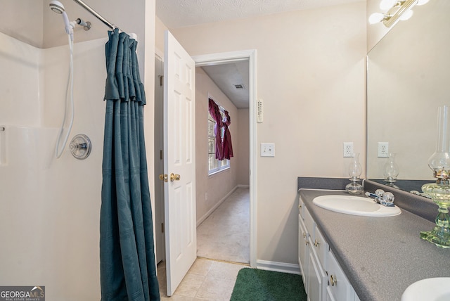 bathroom with baseboards, a shower with shower curtain, vanity, and tile patterned floors