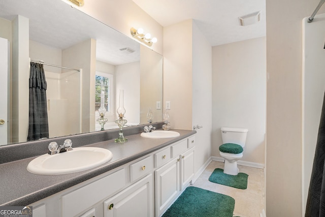 bathroom with toilet, visible vents, and a sink