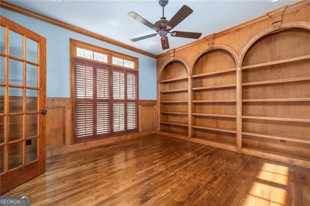 empty room featuring hardwood / wood-style floors, ceiling fan, and crown molding