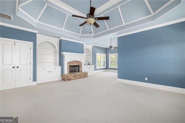 unfurnished living room with carpet flooring, built in features, ceiling fan, and ornamental molding