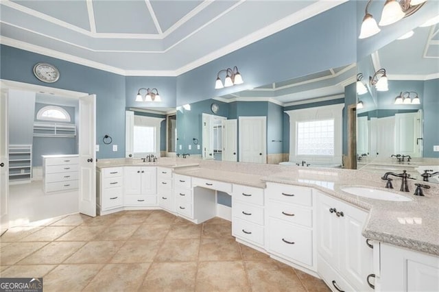 bathroom with a wealth of natural light, crown molding, and vanity