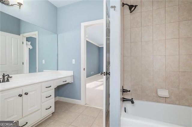 bathroom featuring tile patterned flooring, vanity, and tiled shower / bath combo