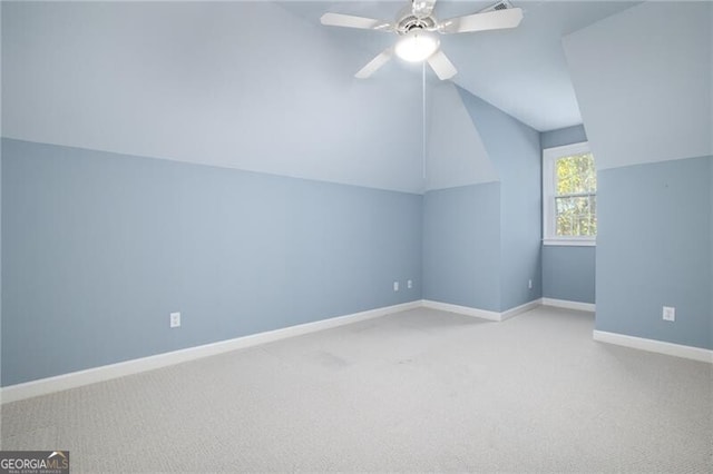 additional living space featuring light carpet, ceiling fan, and lofted ceiling