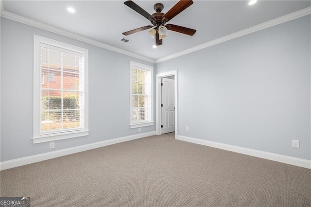 carpeted spare room with ceiling fan and crown molding