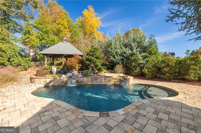 view of swimming pool featuring a gazebo, pool water feature, and a patio area