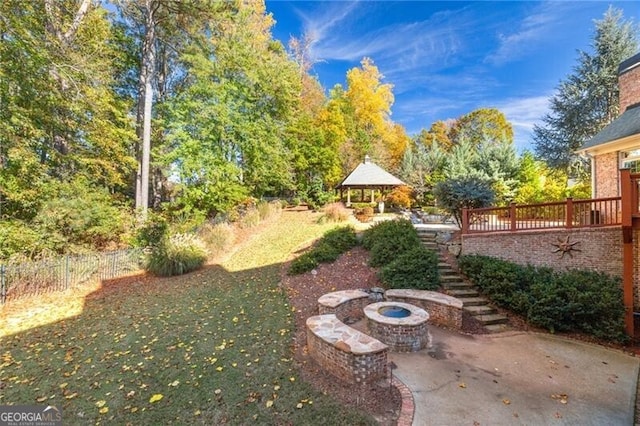 view of yard with a gazebo, a patio, and a fire pit