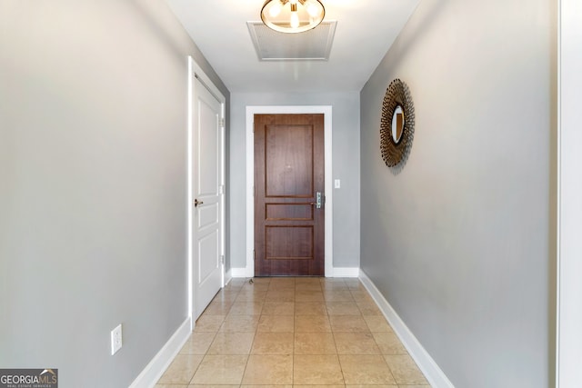 hall featuring light tile patterned floors