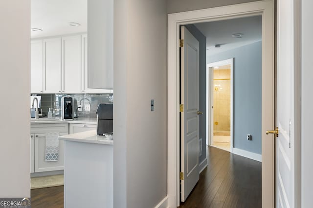 corridor featuring dark hardwood / wood-style flooring and sink