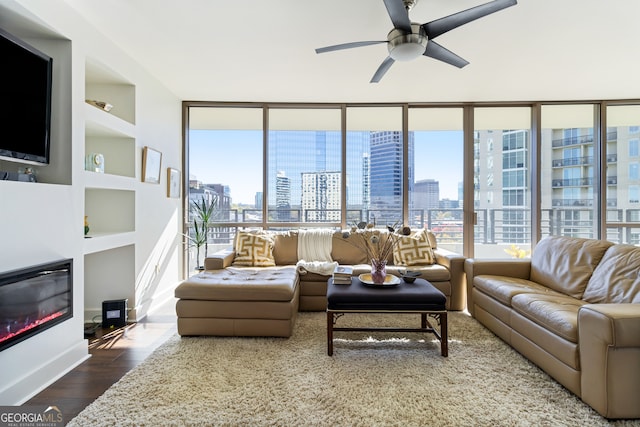 living room featuring hardwood / wood-style floors, ceiling fan, and built in features