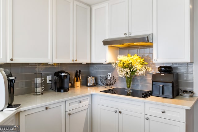 kitchen featuring white cabinets and black electric cooktop