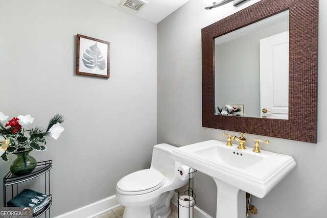 bathroom with tile patterned floors and toilet