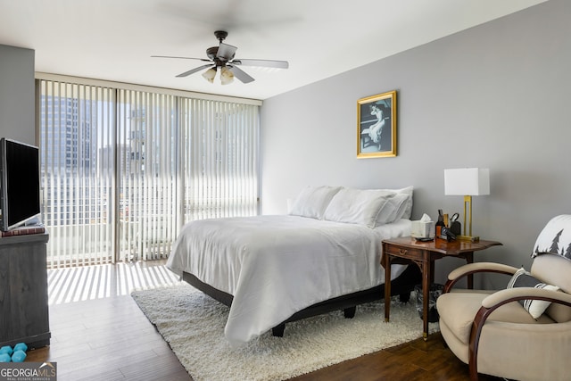 bedroom with ceiling fan, dark hardwood / wood-style flooring, and access to outside