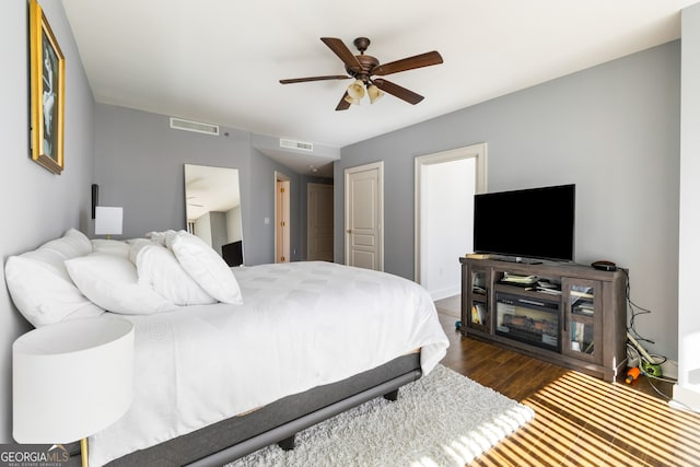 bedroom featuring ceiling fan and dark hardwood / wood-style floors