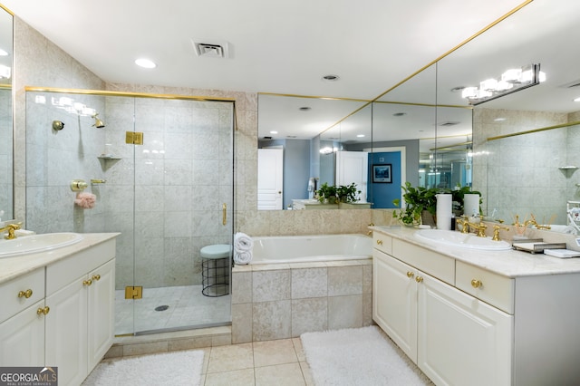 bathroom featuring tile patterned flooring, vanity, separate shower and tub, and tile walls