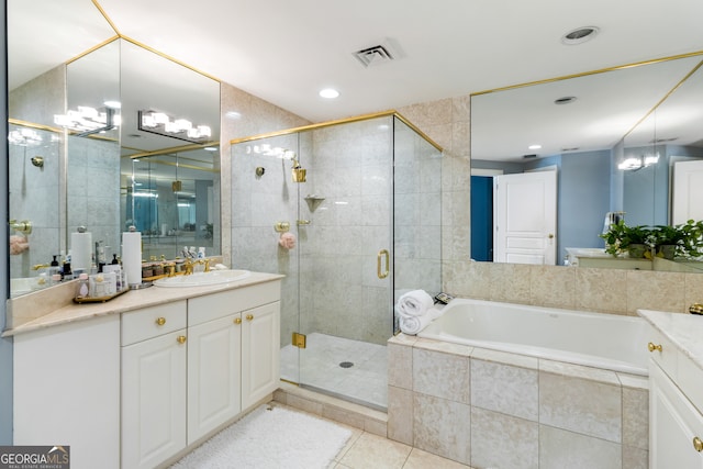 bathroom with tile patterned floors, vanity, and separate shower and tub